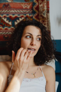 a woman applying lip balm using her fingers