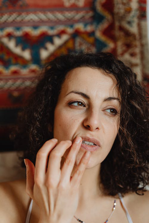 a person applying lip oil on their lips